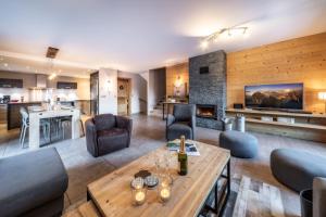 a living room with a table and a fireplace at Chalet du Samoyède in Morzine