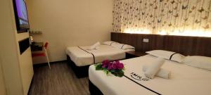 Postel nebo postele na pokoji v ubytování Smile Hotel Cheras Pudu KL