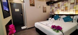 Postel nebo postele na pokoji v ubytování Smile Hotel Cheras Pudu KL