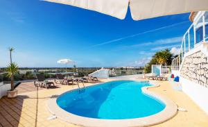 a swimming pool on the roof of a building at Villa Saint John by Algarve Vacation in Albufeira