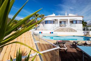 a villa with a swimming pool and a house at Villa Saint John by Algarve Vacation in Albufeira