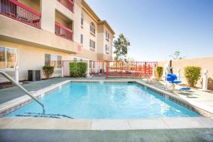 a swimming pool in front of a apartment building at Hawthorn Suites by Wyndham Livermore in Livermore