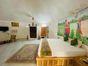 a bedroom with a large bed with a painting on the wall at Desert Nights in Mandāwa