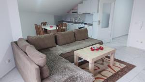 a living room with a couch and a table at Unique Apartmens City Center in Bitola