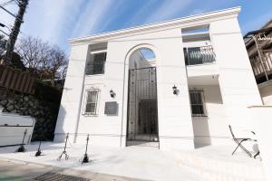 een wit gebouw met een grote deur bij The Guest Villa 箱根湯本 V-II in Hakone