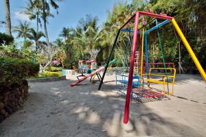 a playground with slides and a swing set at The Jayakarta Yogyakarta Hotel & Spa in Yogyakarta