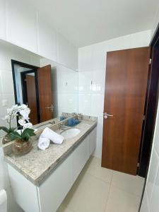 a bathroom with a sink and a mirror at Porto Plaza Flat Service Apt 309 in Porto De Galinhas