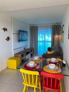 a living room with a table and four chairs at Porto Plaza Flat Service Apt 309 in Porto De Galinhas