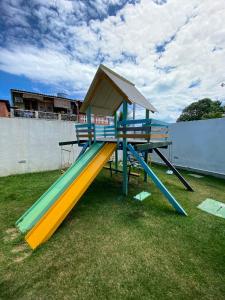 a playground with a slide on the grass at Porto Plaza Flat Service Apt 309 in Porto De Galinhas +37 photos