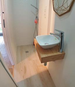 a bathroom with a sink on a wooden counter at Mermaid House- pareado boutique - playa a 200m- pases para piscina externa in Chiclana de la Frontera