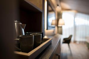 due tazze di caffè sedute su un bancone in una stanza di Hotel Cappella a Colfosco