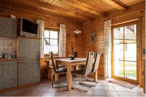 a dining room with a table and chairs at Ferienhäuser zur Schäferei in Mitwitz
