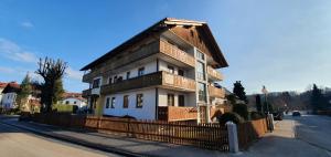 a house with a fence in front of it at Hotel Pension Geiger in Bad Tölz