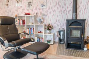 a room with a chair and a fireplace at Ferienwohnung Kramer in Überlingen