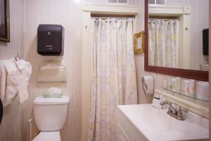 a bathroom with a toilet, sink, and shower at Inn at St John Portland In-Town in Portland