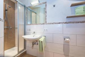 a bathroom with a sink and a shower at Bergbauernhof Seetalhof in Hollersbach im Pinzgau