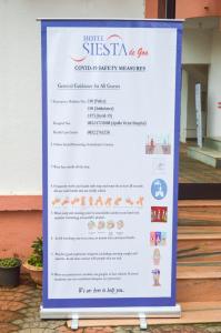 a sign for a seafood restaurant with a menu at Hotel Siesta De Goa in Varca +23 photos