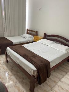 A bed or beds in a room at Apartamento Mobiliado Temporada
