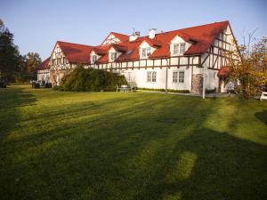 a large house with a large grass field in front of it at Wierzbowe Ranczo - blisko Suntago in Budy Michałowskie