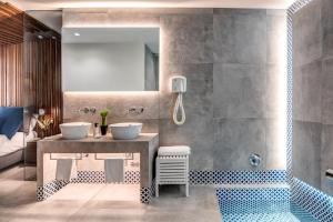 a bathroom with two sinks and a large mirror at Gocce Di Capri Resort in Massa Lubrense