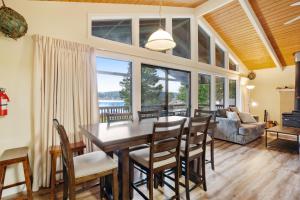a dining room and living room with a table and chairs at Fisherman Bay Beach House in Lopez