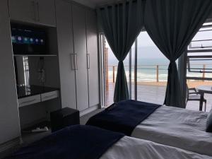 ウィルダネスにあるwilderness oceanviewのベッドがあり海が見える寝室