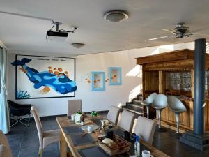 a dining room with a table and a fireplace at wilderness oceanview in Wilderness