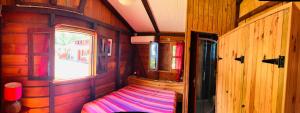 a small room with a bed and a window at Gîtes BB in Bouillante