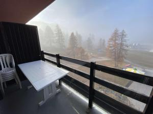 a balcony with a bench and a view of a mountain at Boost Your Immo Le Césier Risoul 411 in Risoul
