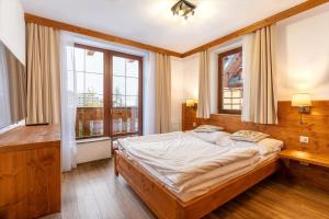 Ein Bett oder Betten in einem Zimmer der Unterkunft Kukučka Lomnica - Tatranská Lomnica