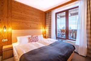 Ein Bett oder Betten in einem Zimmer der Unterkunft Kukučka Lomnica - Tatranská Lomnica