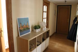 a living room with a cabinet with a picture on it at Amplio apartamento Plaza de Toros in Zaragoza