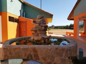 a water fountain in front of a building at Willy's Country Club Cauquenes in De Cauquenes