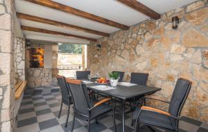 a dining room with a table and chairs at Apartman Genova Imotski in Donji Vinjani