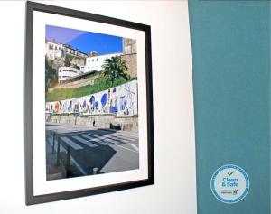 a wall with a picture of a person on it at Vivacity Porto - Rooms & Apartments in Porto