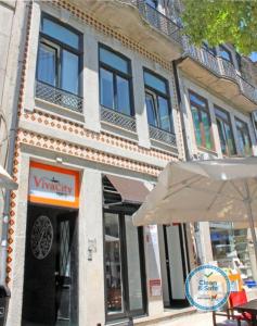 a building with an umbrella in front of it at Vivacity Porto - Rooms & Apartments in Porto