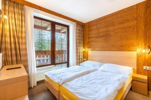 Ein Bett oder Betten in einem Zimmer der Unterkunft Kukučka Lomnica - Tatranská Lomnica