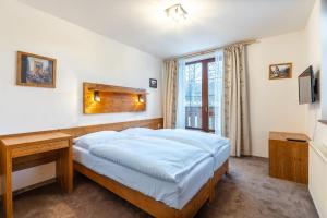 Ein Bett oder Betten in einem Zimmer der Unterkunft Kukučka Lomnica - Tatranská Lomnica