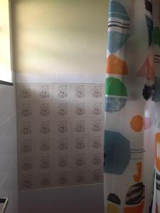 a bathroom with a shower curtain in a room at Chalés na fazenda in Santo Antônio de Posse