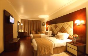 Säng eller sängar i ett rum på Gulf Inn Hotel Deira Formerly City Star Hotel