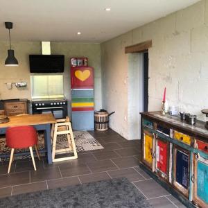 a kitchen with a table and a colorful wall at Le Logis de la Tour Saint Jacques in Chouzé-sur-Loire