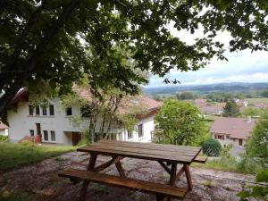 a wooden picnic table sitting on top of a hill at Gîte Le p'tit Chasseral in Maîche