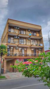 a tall building with cars parked in front of it at Hotel BellMar in K'obulet'i
