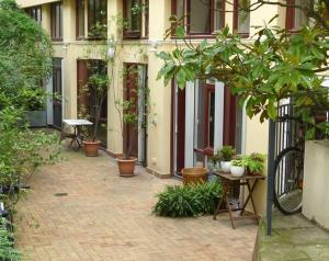 einen Innenhof mit Topfpflanzen vor einem Gebäude in der Unterkunft Studio Fabert in Paris