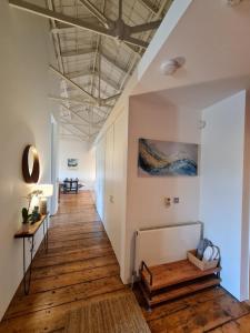 a hallway with wooden floors and white walls and a ceiling at Clarence at Royal William Yard in Plymouth