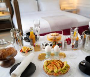 a table with food and eggs and a bed at Baccarat Hotel and Residences New York in New York