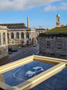 a car parked in a parking lot in front of a building at Clarence at Royal William Yard in Plymouth