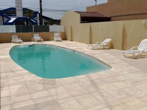 a large swimming pool with chairs at Hotel SKY in San Bernardo