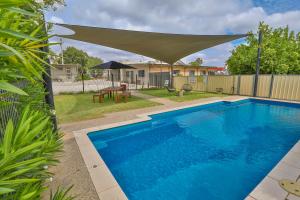 a swimming pool in a yard with a canopy over it at Robinvale Bridge Motel in Robinvale 