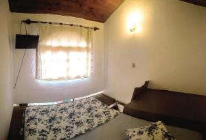 En eller flere senger på et rom på Pousada Em Busca do Sol